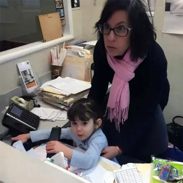 A receptionist and pediatric patient at the front desk