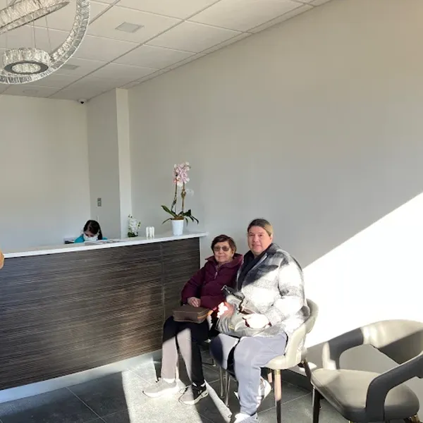 Patients smiling for a photo while waiting for their appointment